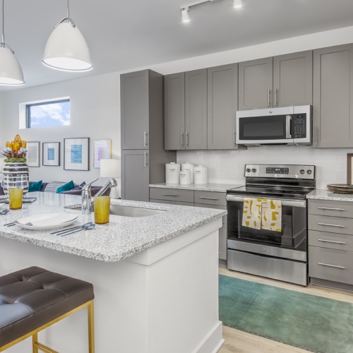 Spacious kitchen with gray cabinetry and kitchen island