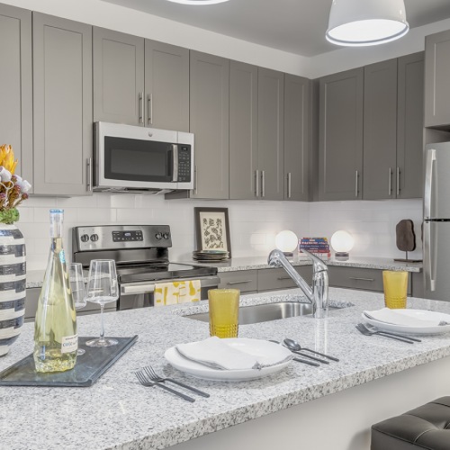 Kitchen with large island and gray cabinetry 